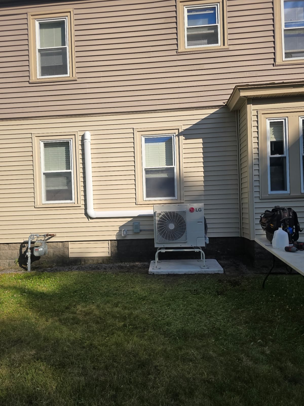 Home exterior showing the outdoor unit and line routing