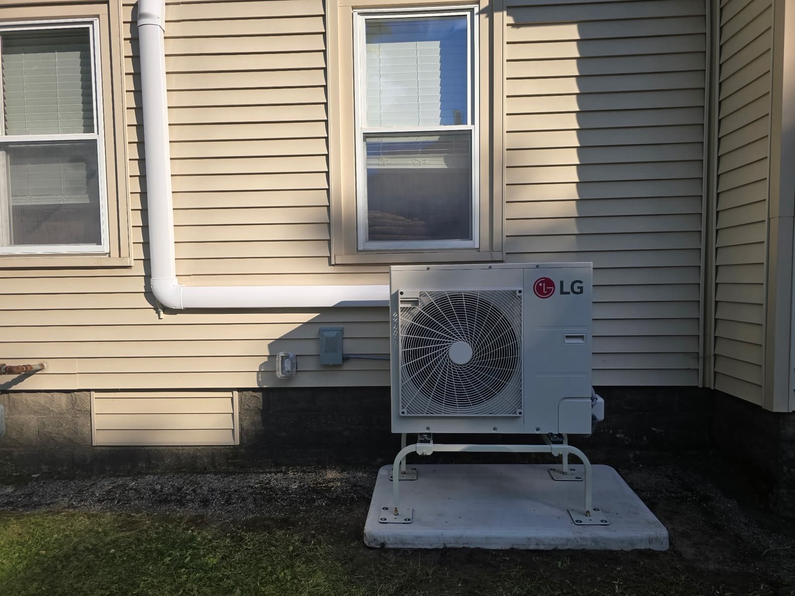 Front view of the outdoor ductless unit on a support pad